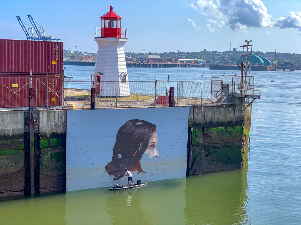 Artist Hula creating his tidal mural in Saint John, New Brunswick - East Coast Mermaid 2