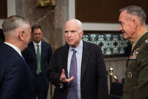 Senator John McCain is pictured greeting Secretary of Defense Jim Mattis and U.S. Marine Corps General Joseph F. Dunford, Jr., Chairman of the Joint Chiefs of Staff, prior to a Senate Armed Services Committee hearing on Capitol Hill on October 3, 2017. The hearing focused on the political and security landscape in Afghanistan, highlighting McCain's continued engagement with national security issues.
