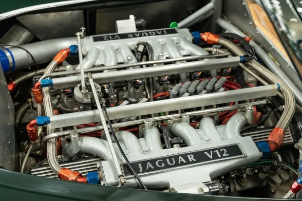 Engine bay of the Jaguar XJ13 replica with red and blue fittings