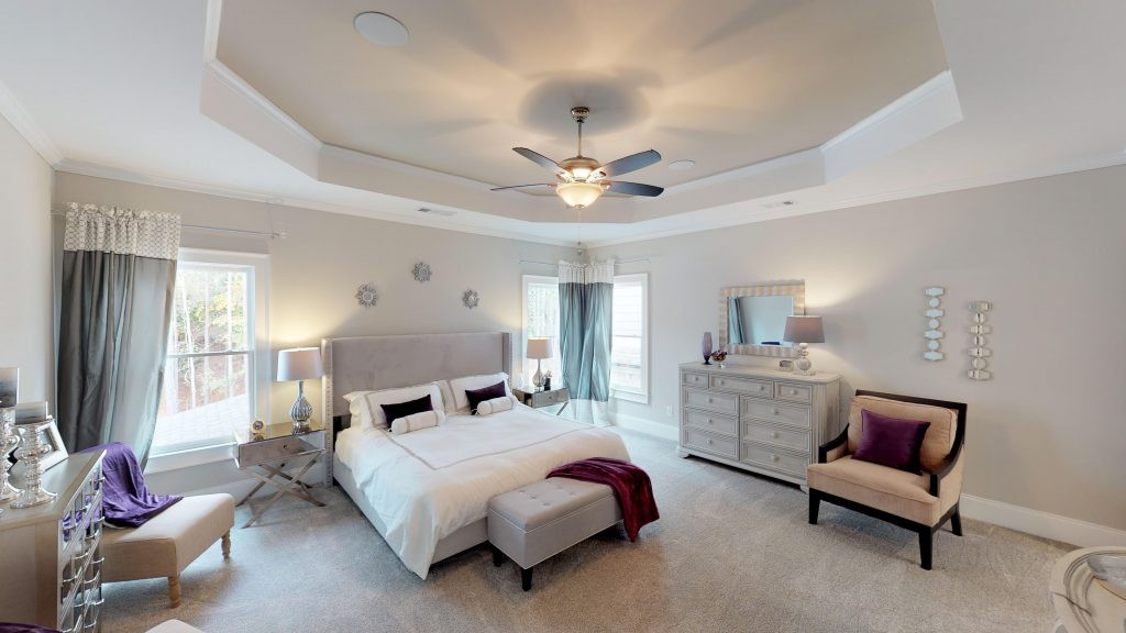 Gourmet kitchen and breakfast area in the Longford model home with island and white cabinets