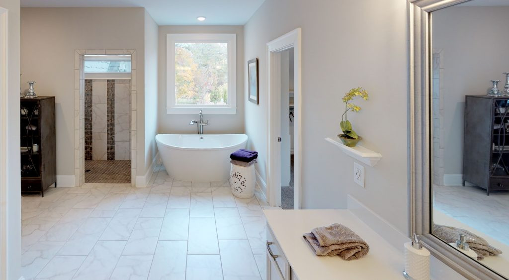Luxurious master bathroom in the Longford model home featuring freestanding tub and walk-in shower