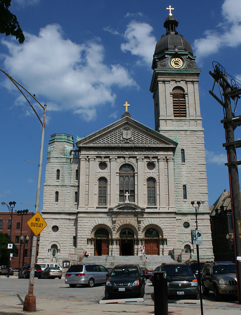 Exterior view of St. John Cantius Church in Chicago showcasing its robust stone facade and classical architectural elements designed by Adolphus Druiding.
