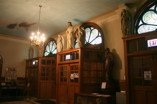 Statues of saints within St. John Cantius Church, highlighting the church's extensive collection of religious art and sculpture.