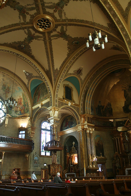 Close-up of the gilded details and intricate artwork within St. John Cantius Church, emphasizing the meticulous restoration and Baroque ornamentation.