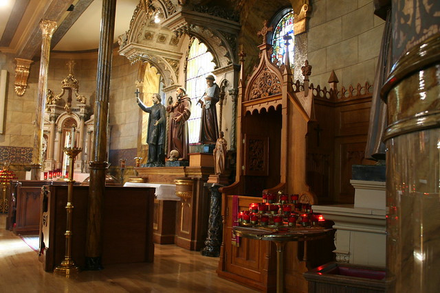 Various statues of religious figures in St. John Cantius Church, emphasizing the devotional atmosphere and artistic detail throughout the sacred space.
