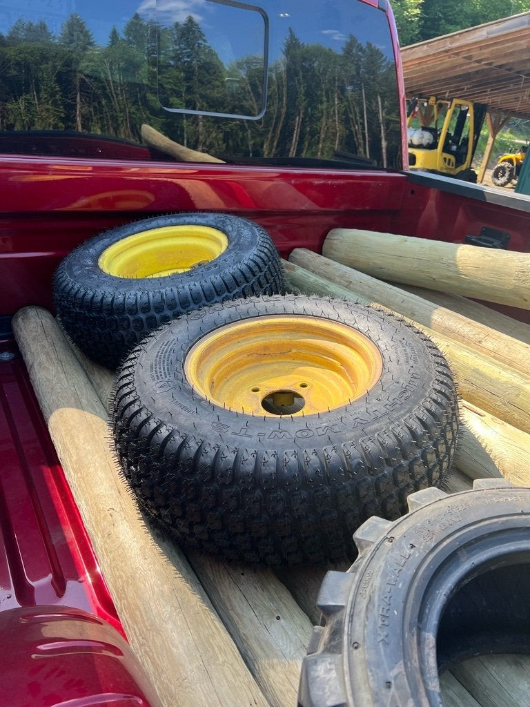 Close-up of the newly installed turf tire on the John Deere 4100, showing tire detail
