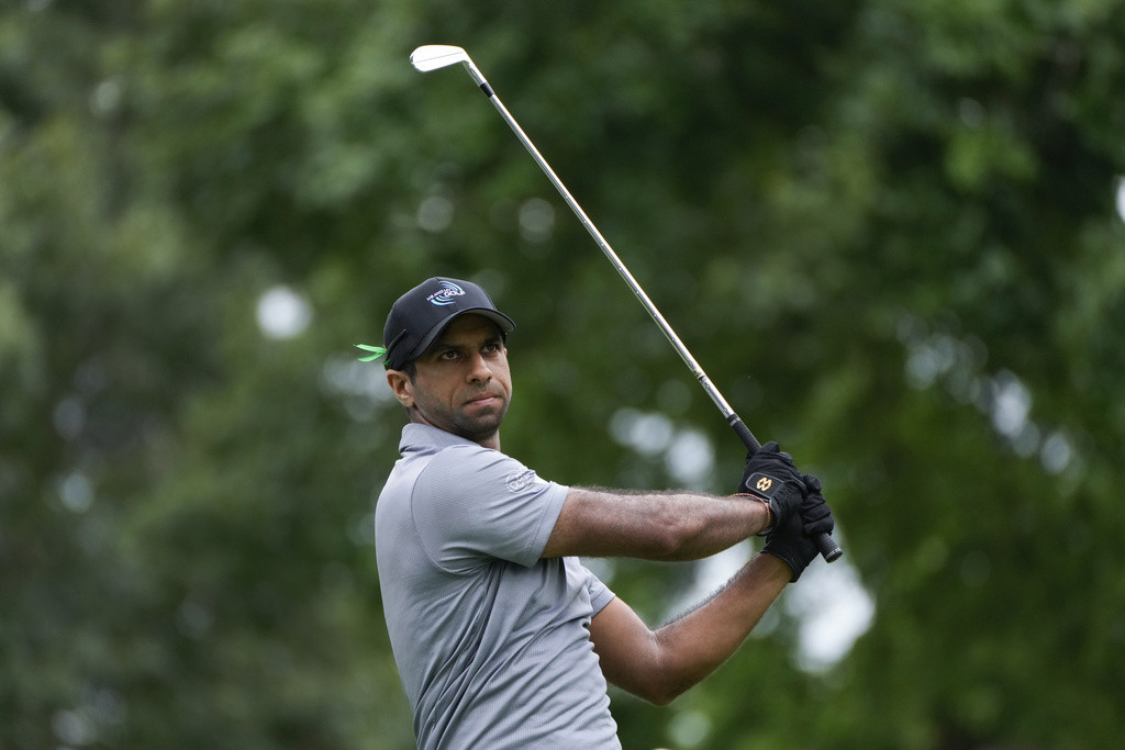 Aaron Rai teeing off at the Rocket Mortgage Classic, focusing on his tee shot accuracy.