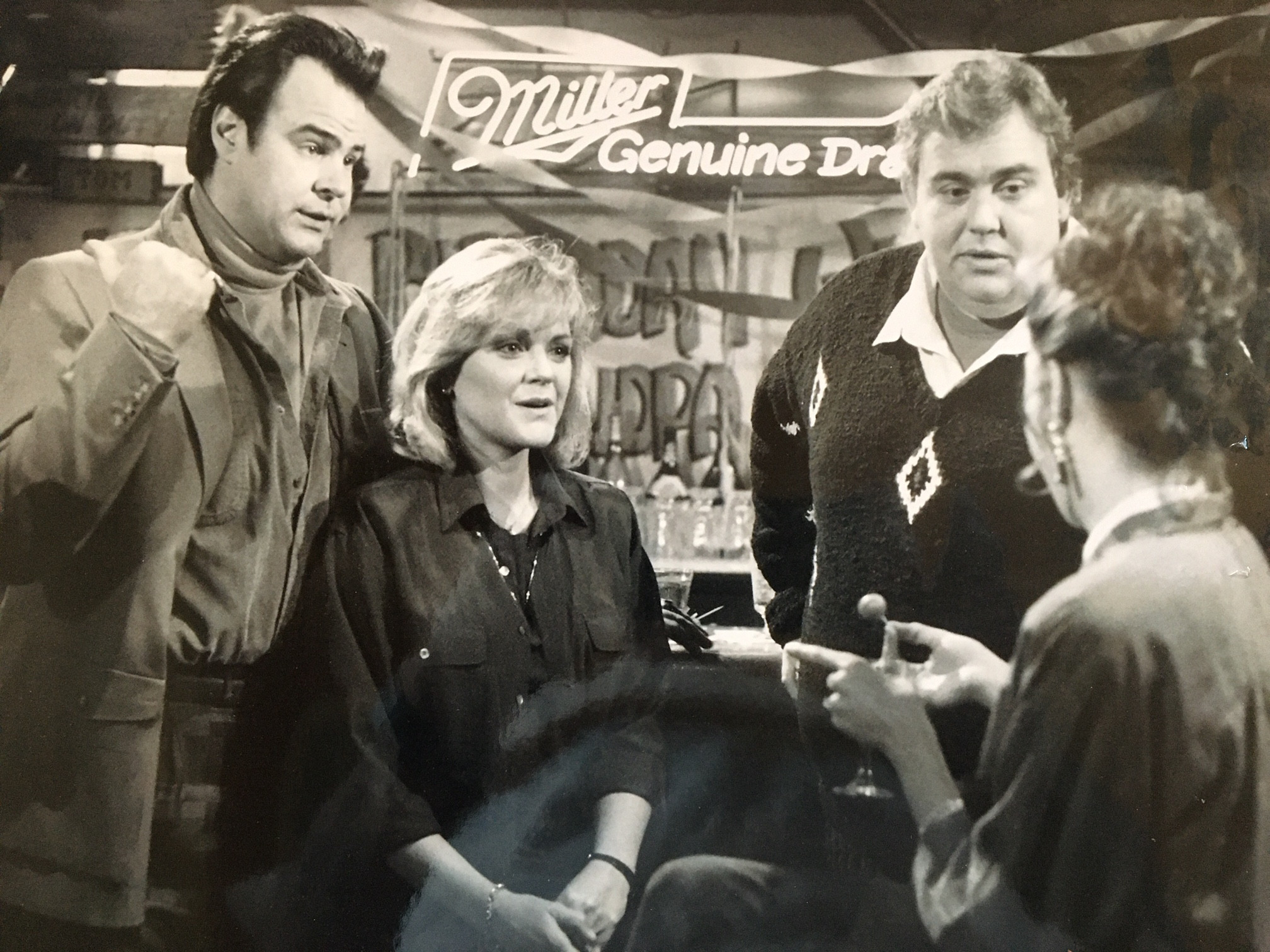 A still from The Great Outdoors movie showing Dan Aykroyd, Stephanie Faracy, John Candy, and Annette Bening inside Ducey's Bar at Bass Lake