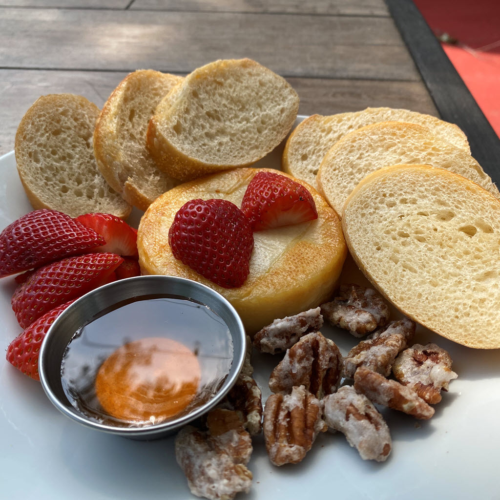 Honey backed Brie with candied pecans, raspberries and toast