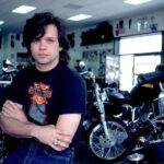 John Mellencamp in a black and white portrait with a serious expression