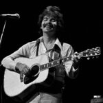 John Prine performing live in Atlanta, Georgia in 1975, capturing the playful spirit of "Illegal Smile".