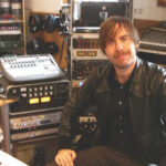 Björn Yttling at work in the studio with vintage synthesizer, showcasing his hands-on approach to music creation for Peter Bjorn and John.