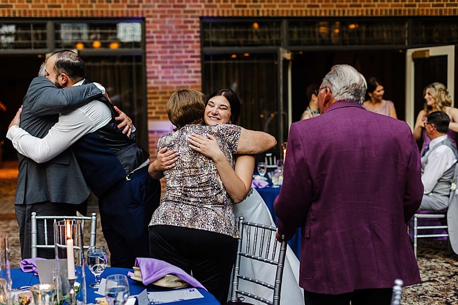 Bride hugging a guest, sharing joy and gratitude at The Inn at St. John's reception.