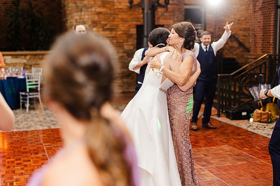 Bride hugging her mother, a loving embrace during the reception at The Inn at St. John's.