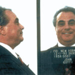 John Gotti, famously known as the Teflon Don, in a photograph highlighting his dapper style and public persona as the boss of the Gambino crime family.