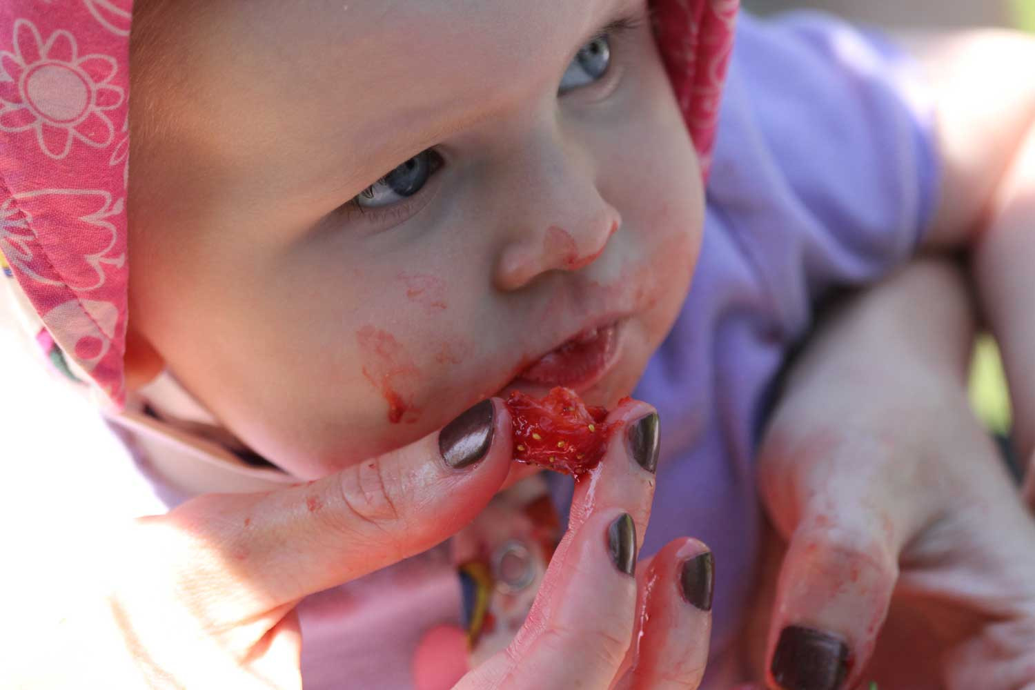 Emma enjoying strawberries, symbolizing savoring life's pleasures