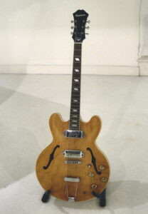 John Lennon with his stripped Epiphone Casino