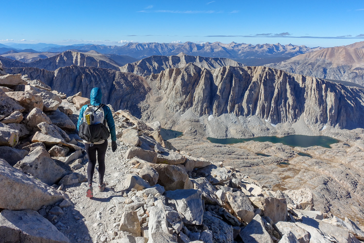 Backpacker descending a summit trail of Mt. Whitney