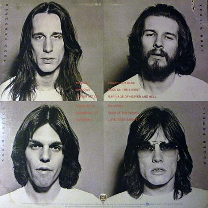 Utopia band photo featuring Todd Rundgren, John "Willie" Wilcox, Roger Powell, and Kasim Sultan, promoting their transition from prog rock to a more melodic sound.