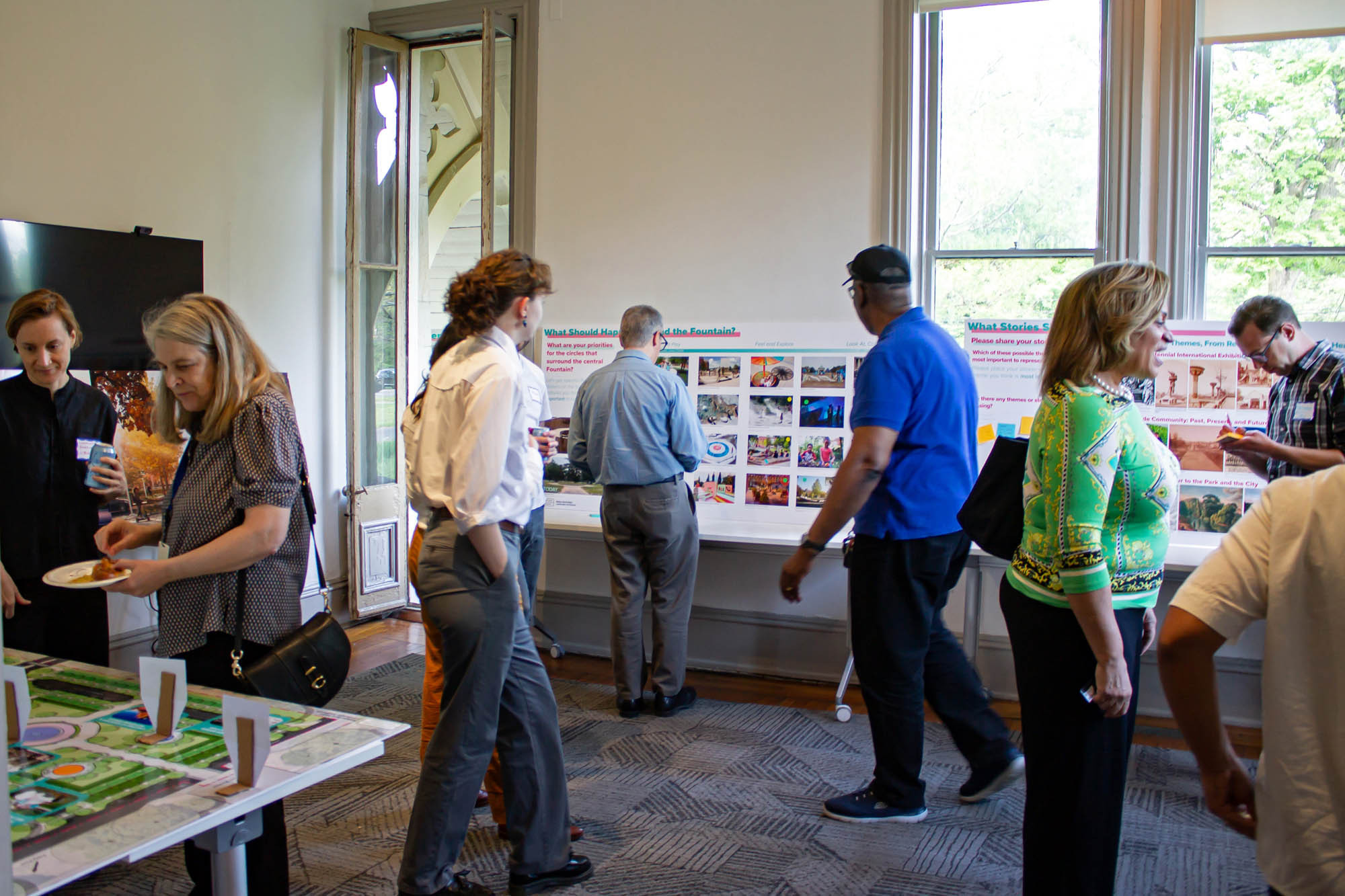 Community members engaging in interactive activities at the Center for Parks at Ohio House, discussing the Welsh Fountain project