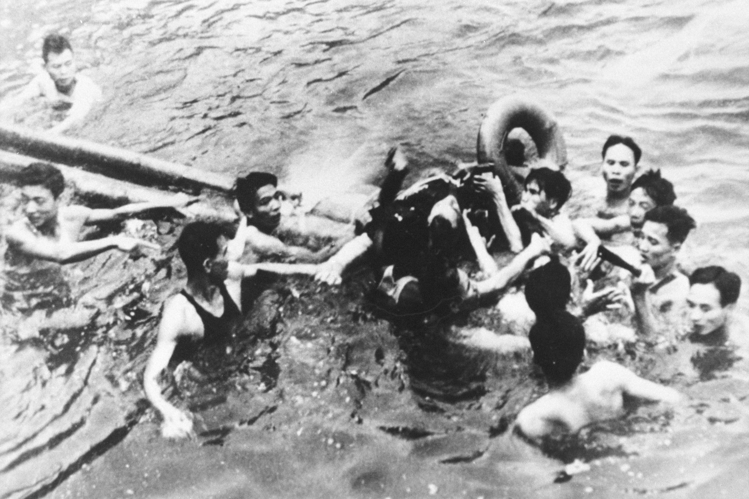 Senator John McCain is pulled out of a Hanoi lake by North Vietnamese army soldiers and civilians on Oct. 26, 1967
