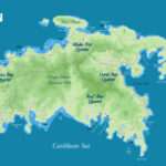 Aerial view of Cruz Bay, St. John, showcasing its harbor, commercial center, and surrounding beaches.